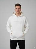 Man wearing a white hoodie with text on a gray background
